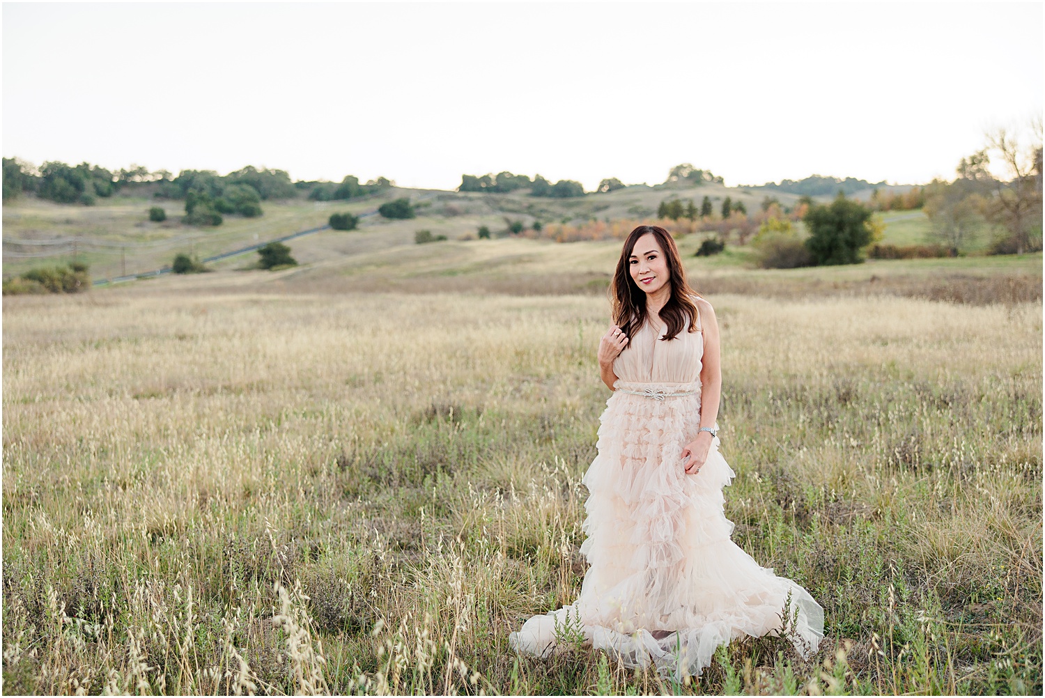 50th Birthday Photo Session | Woman in field in nude tulle dress