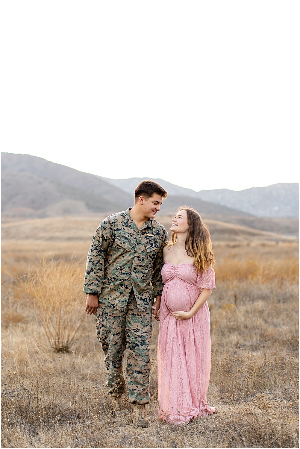 Maternity Photo Session Tips | Maternity photos, couple in field, mommy-to-be in pink lace maxi dress, husband in military uniform 