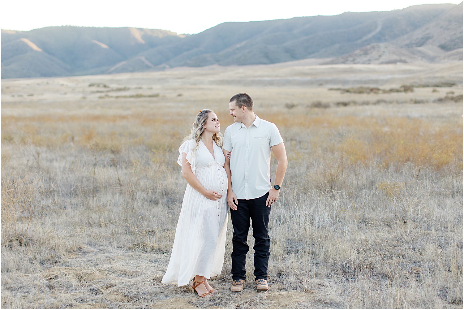 Maternity Photo Session Tips | Maternity photos, couple in field, mommy-to-be in white pleated maxi dress