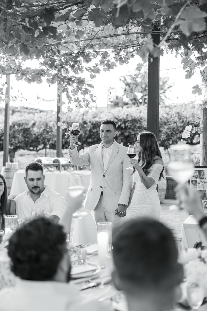 southern california wedding welcome party dinner Wilson Creek winery couple toasting with guests