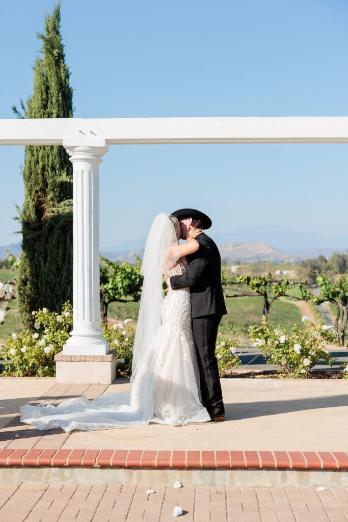 bride and groom first kiss