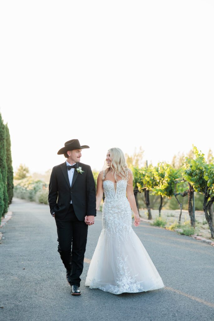 Southern California winery wedding photographer | bride and groom sunset photos, walking hand in hand 